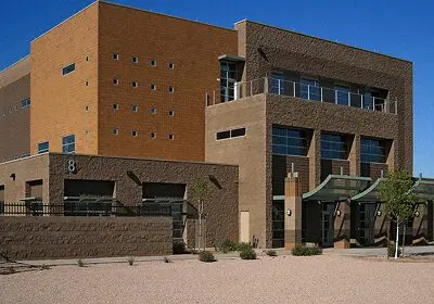 Modern brick and glass building under clear blue sky.