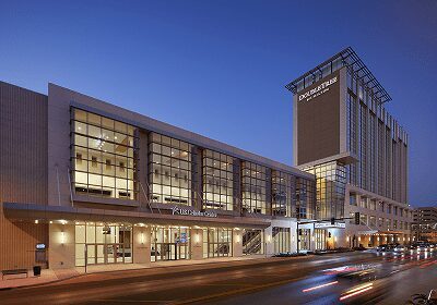 Modern building with glass windows illuminated at dusk.