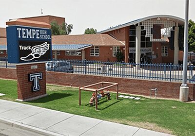 Temple High School entrance with a welcoming sign and American flag.