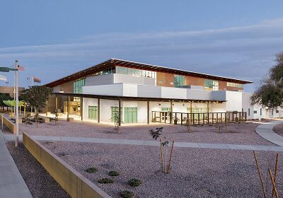 Modern commercial building with large windows and a wooden facade.